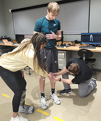 photo of 3 students doing research about ACL injuries